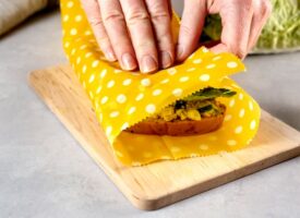 hands wrapping a healthy sandwich in beeswax